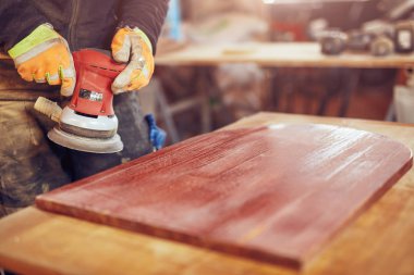 Erkek marangoz bir retro vintage orbital elektrikli zımpara kullanarak 