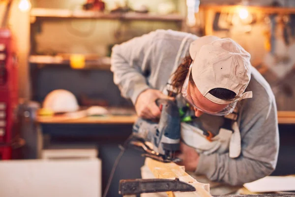 Male carpenter working on old wood in a retro vintage workshop. — Stock Photo, Image