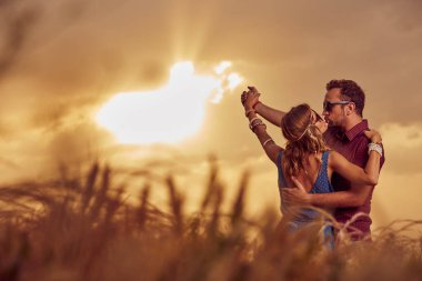 Bir buğday alanında günbatımı/gündoğumu zaman çift.