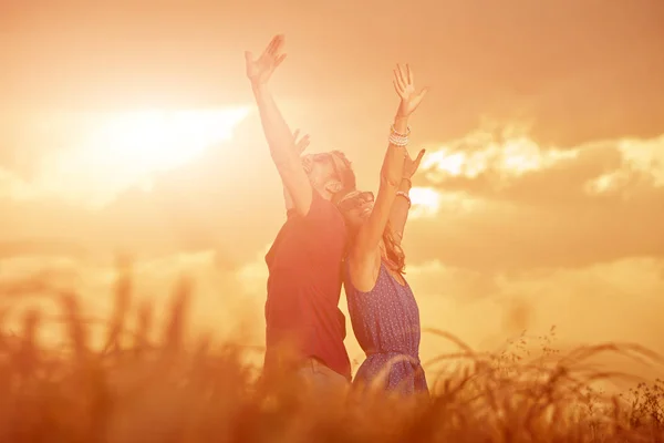 Couple in sunset / sunrise time in a wheat field.