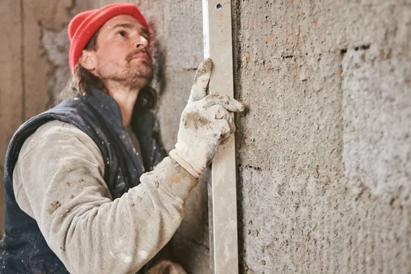 Lucrător real în construcții care face un zid în interiorul noii case . — Fotografie, imagine de stoc