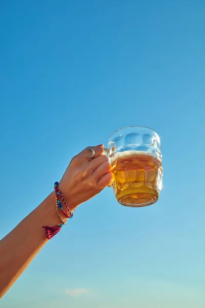 Woman holding glass of beer outdoors / outside. Royalty Free Stock Photos