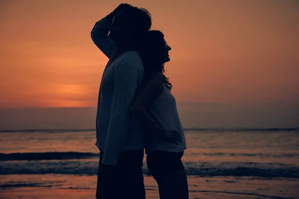 Silhouette of a girl in sunset / sunrise time over the ocean. Stock Image