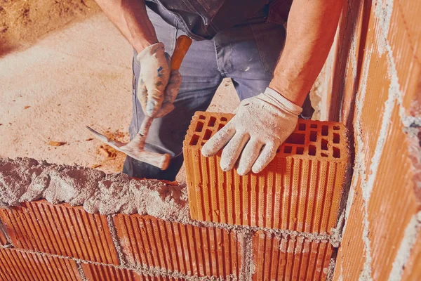 Real construction worker bricklaying the wall indoors. — Stock Photo, Image