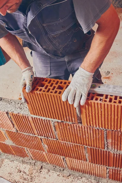 Real construction worker bricklaying the wall indoors. — Stock Photo, Image