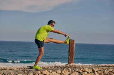 Okyanus yakınında tropikal egzotik uçurumun üzerinde uzanan Sportsman.