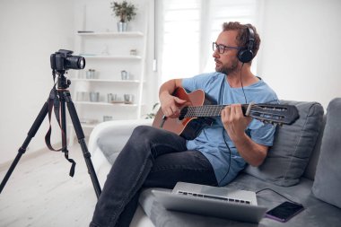 İnternet vlog web sitesi dersleri için video dersleri ve dersler hazırlayan gitarist.