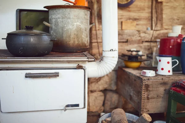 Old stove with pots used for cooking food on a traditional old way.