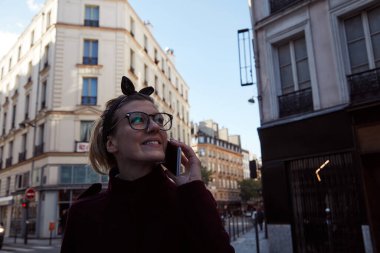 Paris, Fransa sokaklarında akıllı telefon kullanan bir kadın..