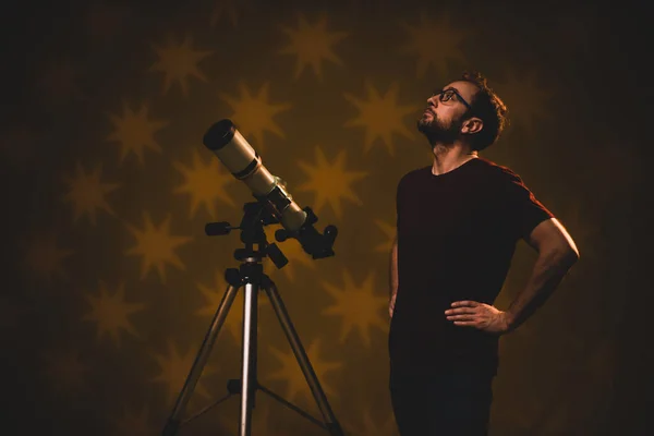 Amateur astronomer looking at the stars with a telescope. Astronomy and astrology concept.