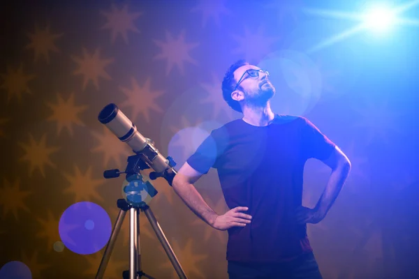 Amateur astronomer looking at the stars with a telescope. Astronomy and astrology concept.