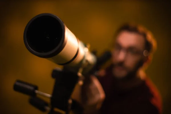 Amateur astronomer looking at the stars with a telescope. Astronomy and astrology concept.