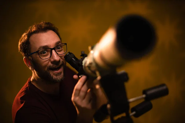 Amateur astronomer looking at the stars with a telescope. Astronomy and astrology concept.