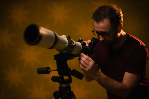 Amateur astronomer looking at the stars with a telescope. Astronomy and astrology concept.