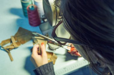 Evde retro dikiş makinesi kullanan bir kadın terzi, hobi konsepti..