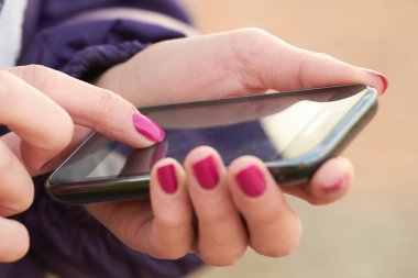 Modern bir akıllı telefon tutan kadınların yakın plan fotoğrafları..