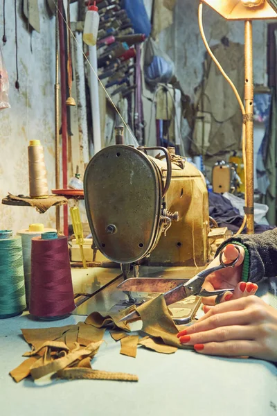 Evde retro dikiş makinesi kullanan bir kadın terzi, hobi konsepti..