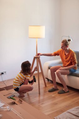 Anne ve kızı yeni bir eve taşınmak için yeni mobilya monte ediyorlar..