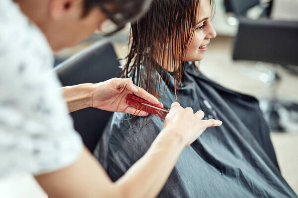 Hairdresser cutting hair in a salon.