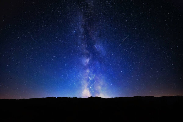 Milky Way stars and rural countryside silhouettes