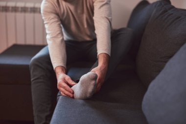 Ayak bileği ve ayak ağrısı olan bir adam..