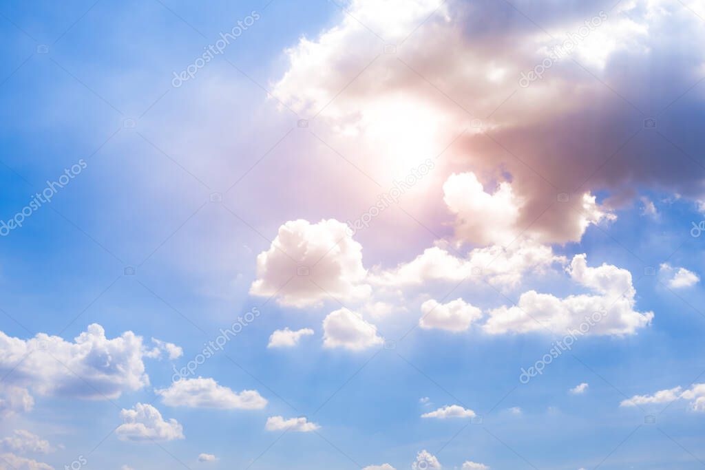The clear sky view with white clouds and sunlight.