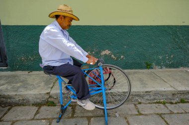 San Cristobal de las Casas, Mexico - March 18, 2025: A man sharpening knives on a street in San Cristobal de las Casas, Chiapas, Mexico.