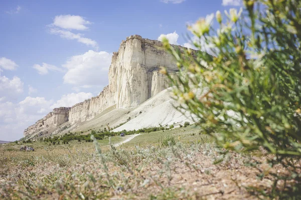 View of White rock or Aq Qaya on a Sunny summer day. Crimea. White limestone with a vertical cliff.