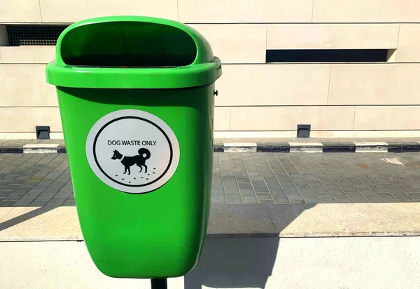 Green recycle bin for dog waste only