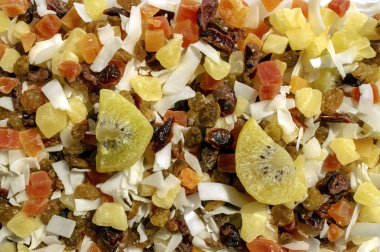 Karışık meyveler, kuru üzümler ve hindistan cevizi gevreklerinden oluşan bir arka plan. Sağlıklı atıştırmalık ve yiyecek. Üst Manzara. Asya kokteyli. 