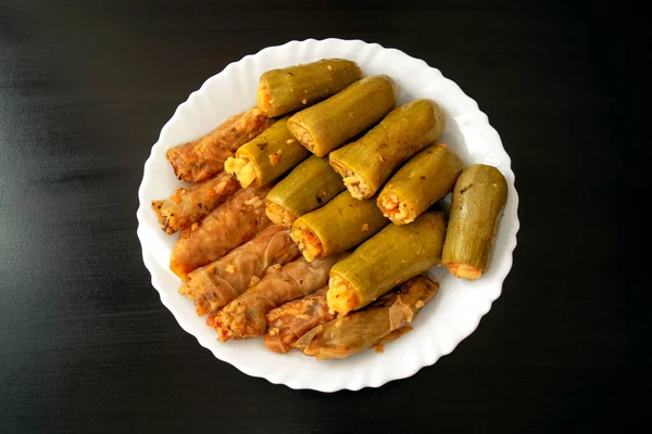 Rouleaux traditionnels de courge farcis et de chou sur plaque blanche sur fond de bois foncé. Célèbre Moyen-Orient traditionnel, égyptien, cuisine asiatique. Mahshi ou mahshy, légumes farcis. — Photo