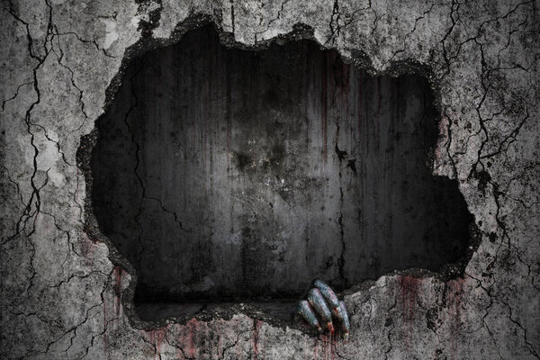 Hand of devil has stains and drops of blood and holding the dama