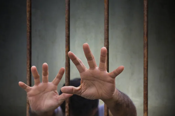 Man Hands of the prisoner desperate to catch the old prison rust Stock Photo