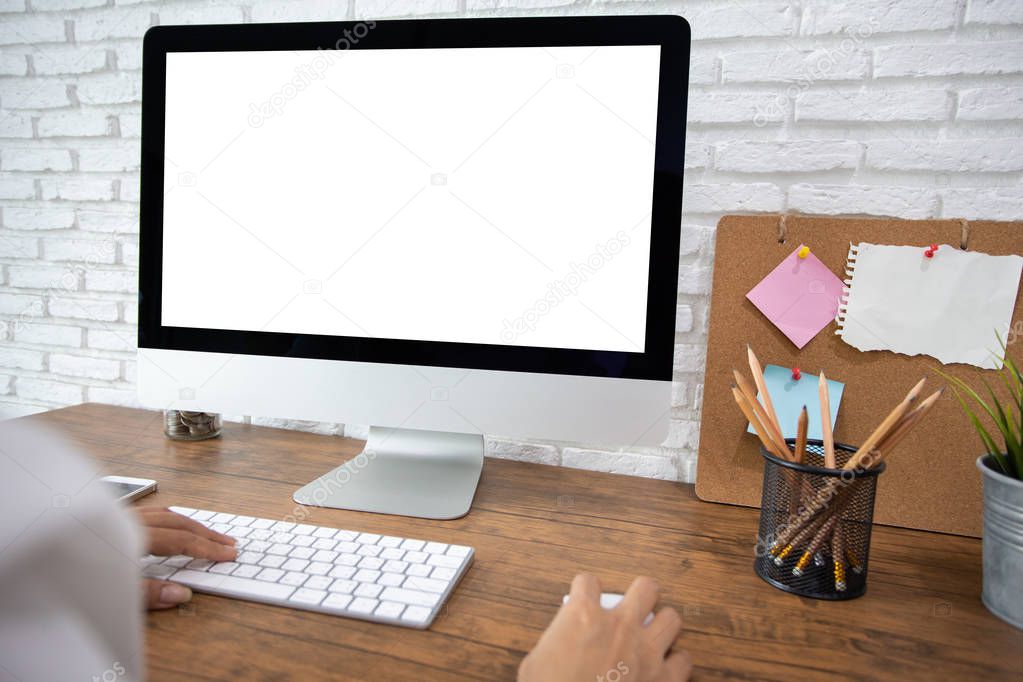 woman working empty screen computer on wood desk in home office. with clipping path