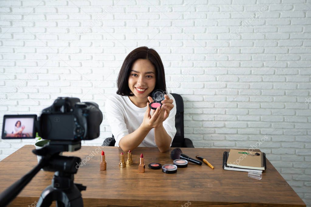 Beauty bloggers, Asian Women Showing cosmetic products while rec