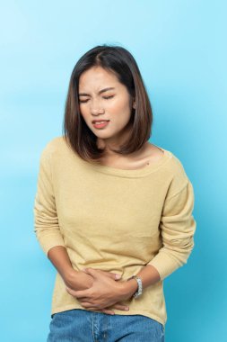 asian young woman having painful stomachache 