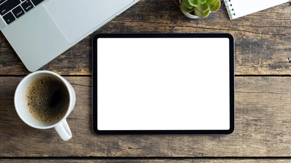 Mockup image tablet with blank white screen on wooden table