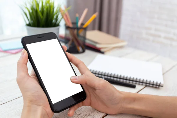 hand woman using a telephone, empty screen smart phone and computer on wooden table In home office. with clipping path