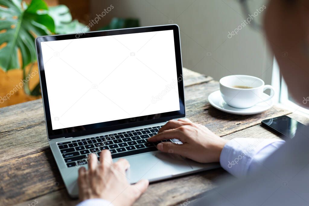 mock up business woman working empty screen computer on wood desk in Coffee shop
