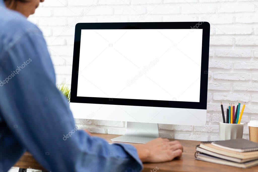 man working empty screen computer on wood desk in home