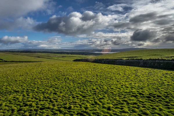 Green Ireland countryside with clouds