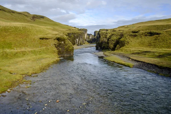 River flow through the canyon of Fjadrargljufur in Iceland Stock Photo