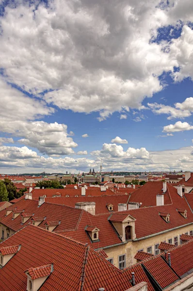 View over red rooftops of Prague with beautiful clouds