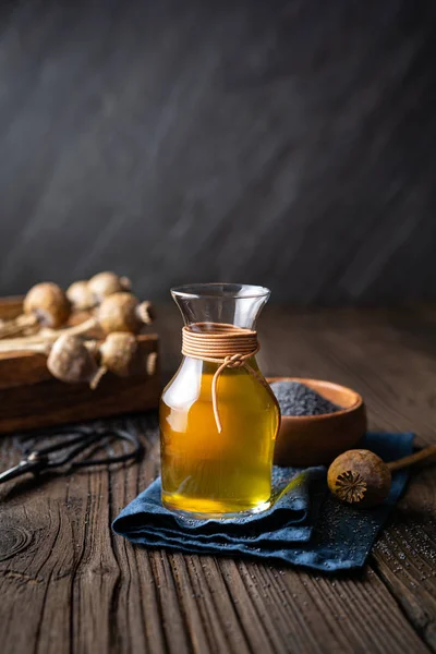 Organic cold pressed poppy seed oil in a glass carafe — Stock Photo, Image