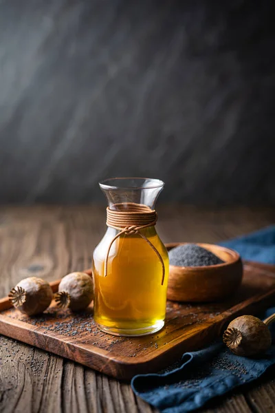 Organic cold pressed poppy seed oil in a glass carafe — Stock Photo, Image