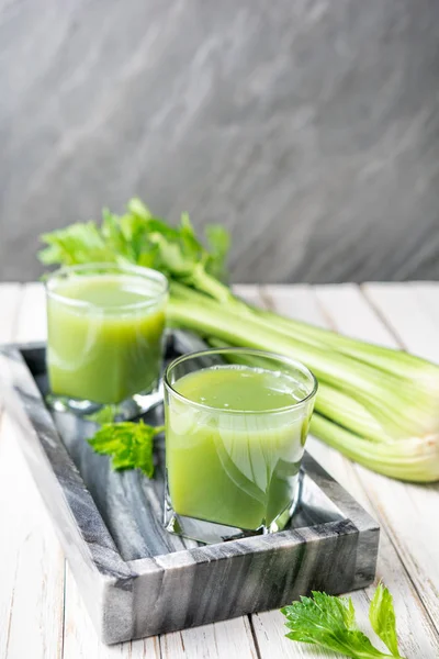 Freshly made pure celery juice in glass jars with copy space