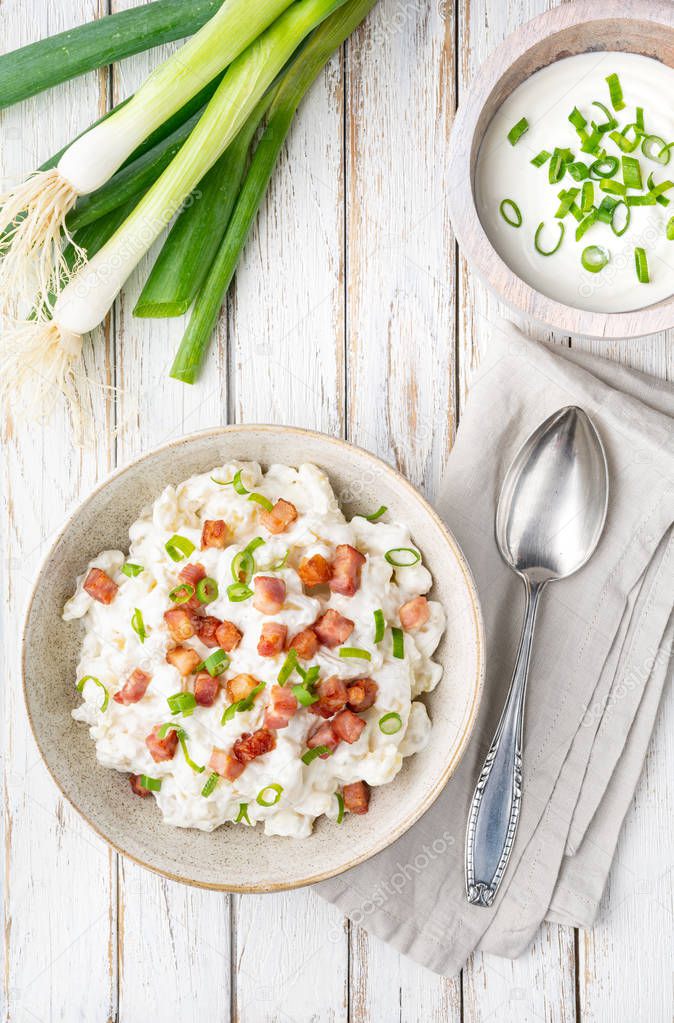 Bryndzove Halusky, national dish in Slovakia, potato dumplings with sheep cheese and sour cream, topped with roasted bacon pieces and spring onion