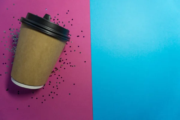 Paper coffee cup to go on blue background
