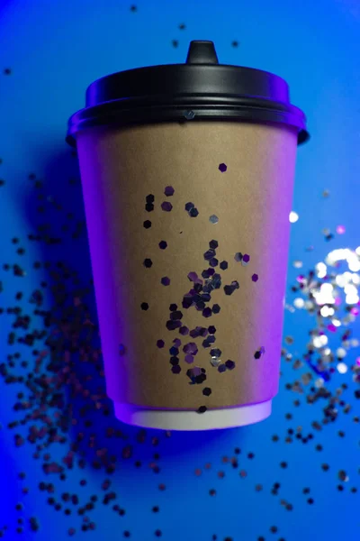 Paper coffee cup to go on blue background