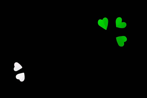 Top View Of Paper Made Green & White Hearts On A Black Background